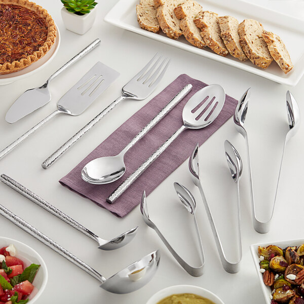 A table set with Carlisle Terra hammered stainless steel utensils.