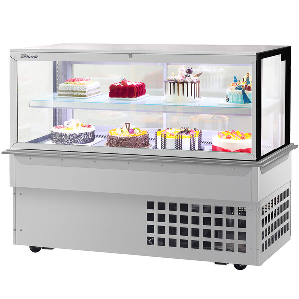 A Turbo-Air square glass two tier drop-in refrigerated bakery display case filled with cakes.
