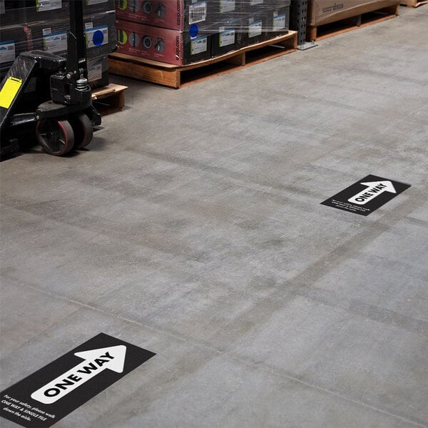 A warehouse floor with E-Z Up black rectangle floor decals.
