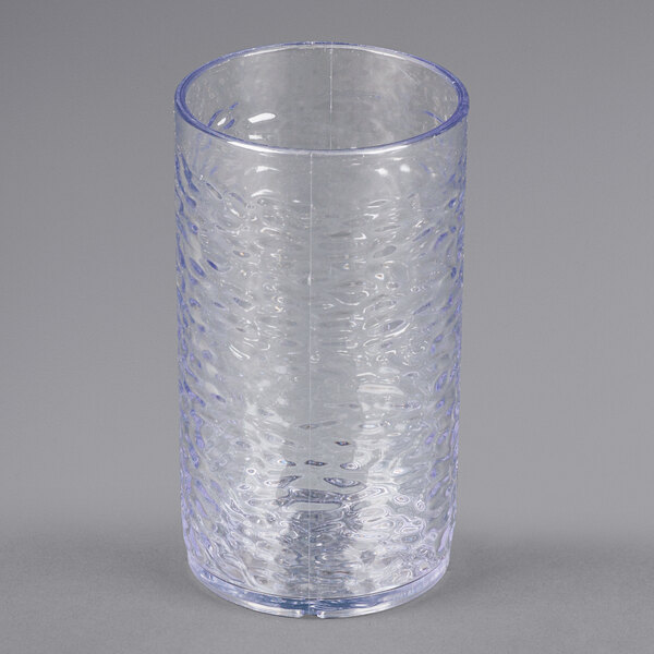 A clear plastic tumbler with a pebble optic design.