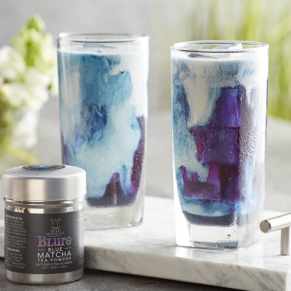 Two glasses of blue and white liquid made with Wild Hibiscus Butterfly Pea Flower Blue Matcha Tea.