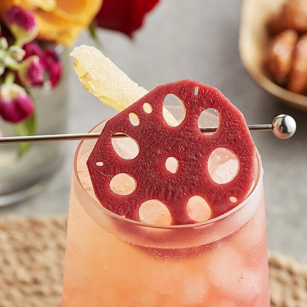 A cocktail with a Wild Hibiscus Lotus Root in Hibiscus and Ginger Syrup in it.