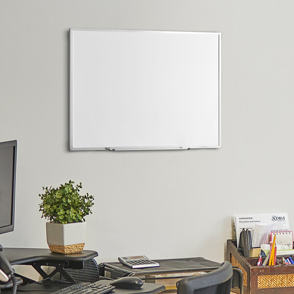 A Dynamic by 360 Office Furniture white board mounted on a wall.