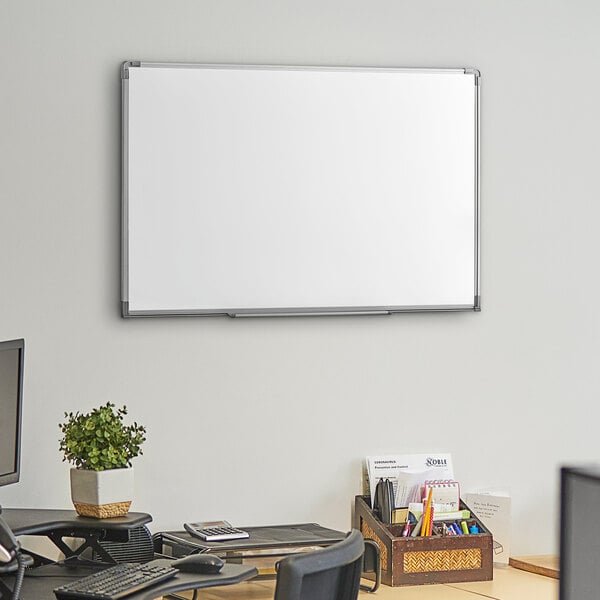 A Dynamic by 360 Office Furniture wall-mounted whiteboard with aluminum frame on a wall.