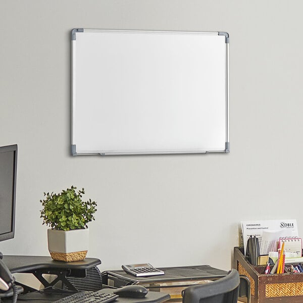 A Dynamic by 360 Office Furniture wall-mount magnetic whiteboard with an aluminum frame on a wall.