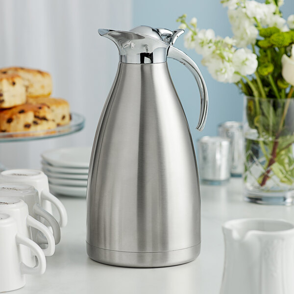 An Acopa Lustrous stainless steel thermal carafe on a table.