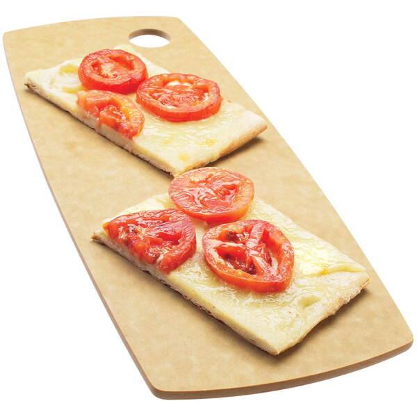 A piece of bread with tomatoes on a Cal-Mil natural rectangle bread board.
