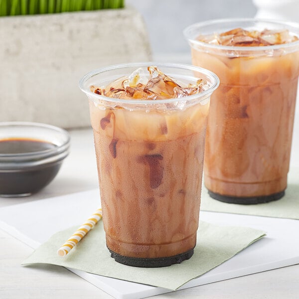 A couple of plastic cups of Bossen brown sugar iced coffee.