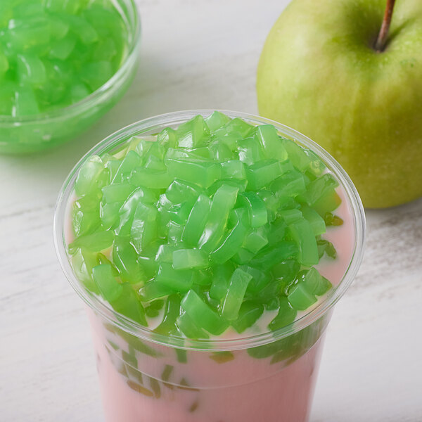 A green apple and a bowl of green jelly.
