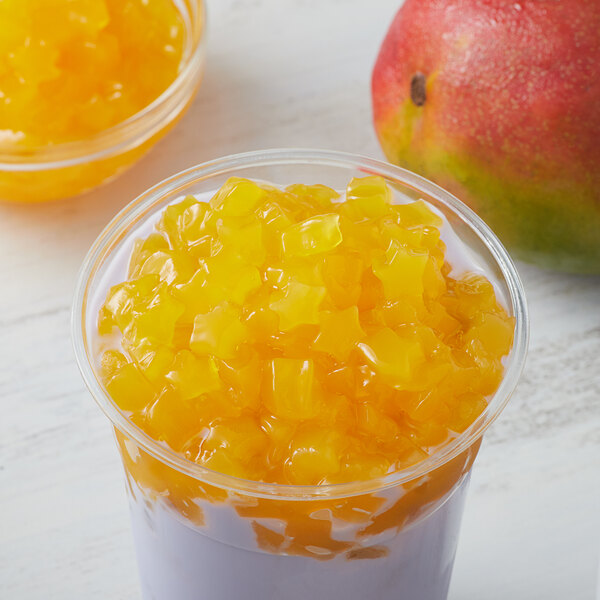 A cup of fruit with star-shaped mango jelly topping.
