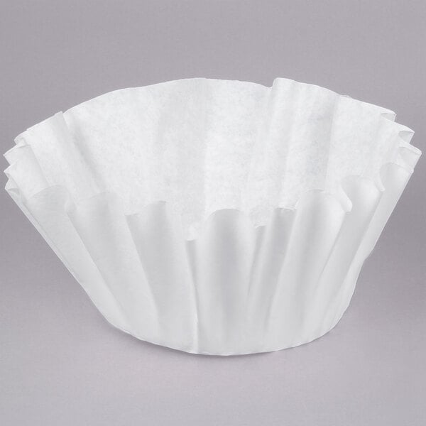A Bunn white paper coffee filter on a gray background.