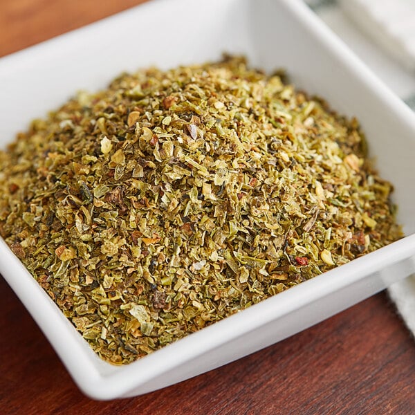 A bowl of Regal green bell pepper granules on a table.