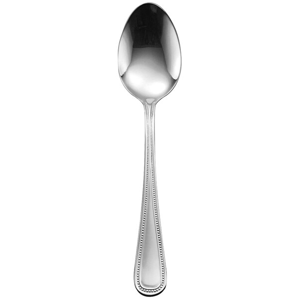 A Delco Prima stainless steel serving spoon with a long handle.
