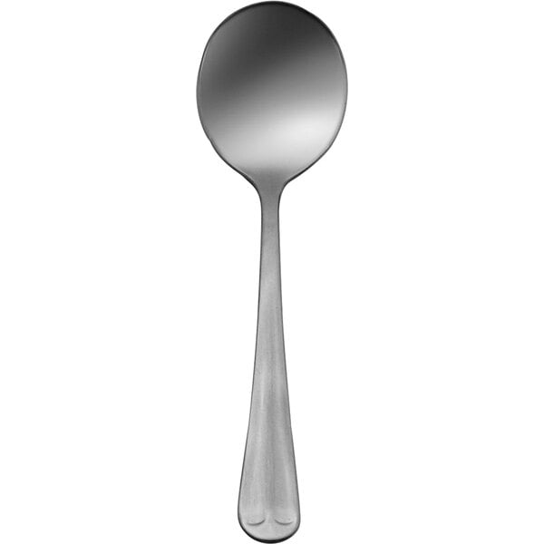 A Delco Old English stainless steel bouillon spoon with a white background.