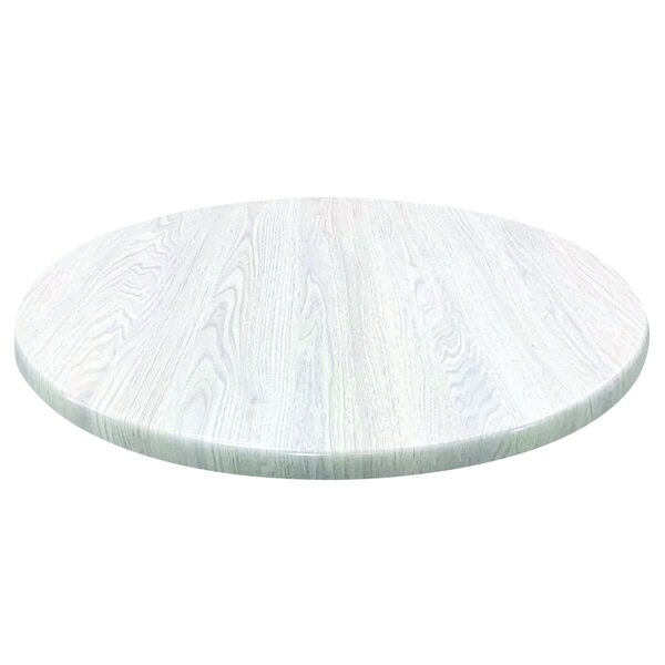 A white round table top with a white wood surface.