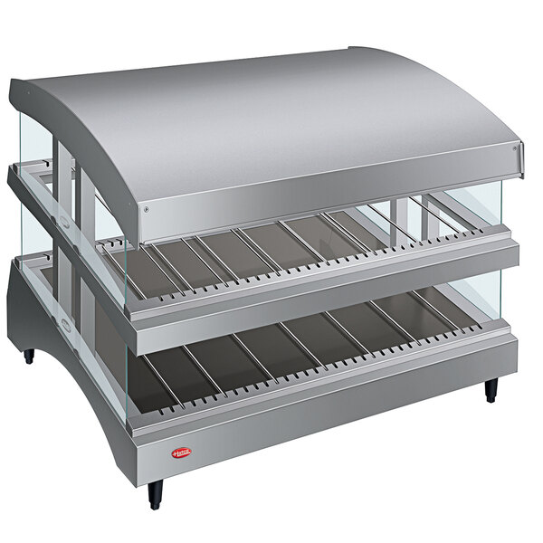 A Hatco countertop heated glass food warmer with slanted shelves.