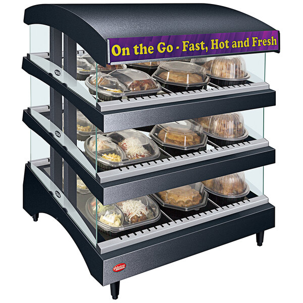 A Hatco countertop heated glass display case with food trays inside.