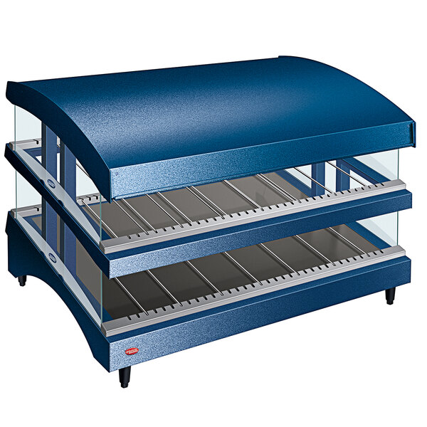 A blue Hatco countertop heated glass merchandising warmer with slanted shelves.