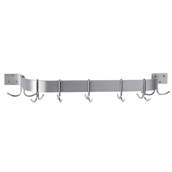A stainless steel wall mounted pot rack with hooks on it.