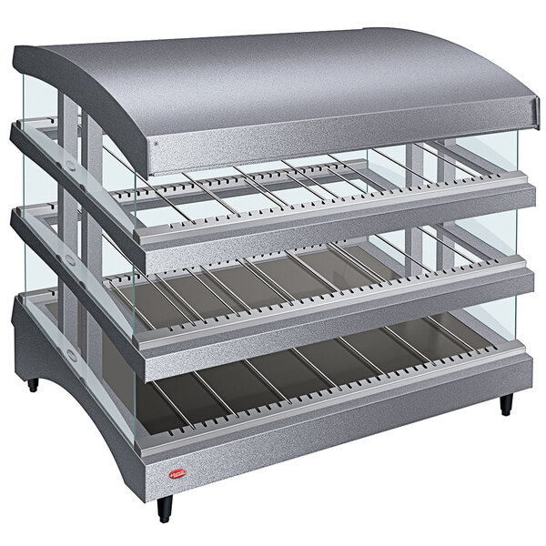 A Hatco countertop heated glass merchandising warmer with three slanted glass shelves.