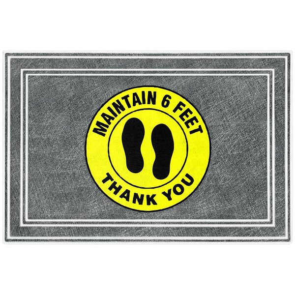 A gray and yellow rubber entrance mat with black text that says "Thank You" and black footprints.