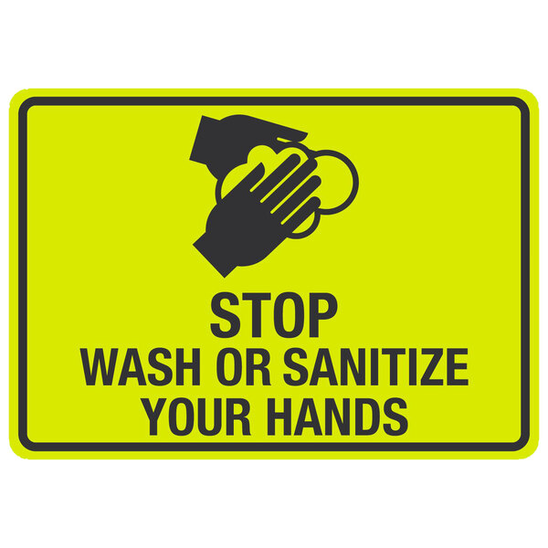 A yellow sign with black text and hands washing that says "Stop / Wash Or Sanitize Your Hands" with a symbol.