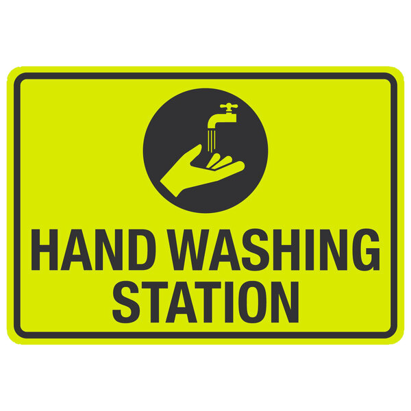 A yellow and black aluminum sign with the words "Hand Washing Station" and a symbol of a hand over a faucet.