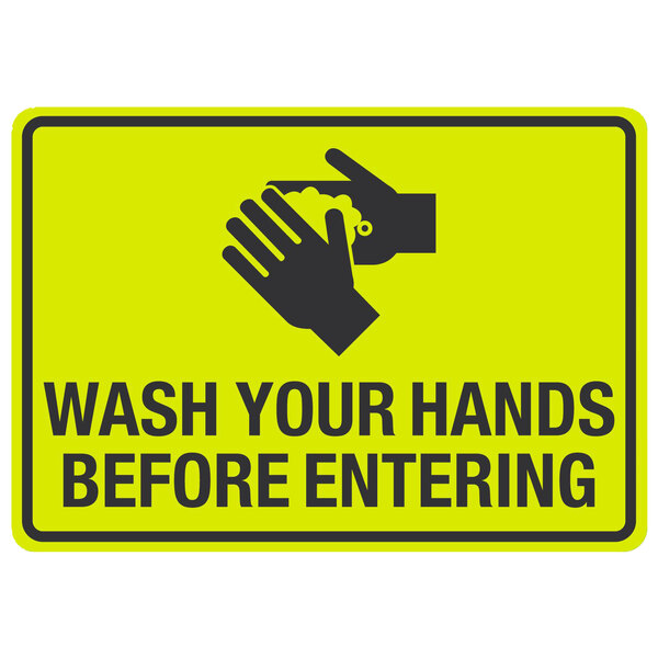 A black and yellow sign with the words "Wash Your Hands Before Entering" and a symbol of hands washing.