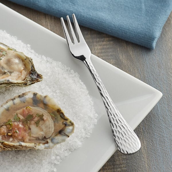 A plate of oysters with a fork.