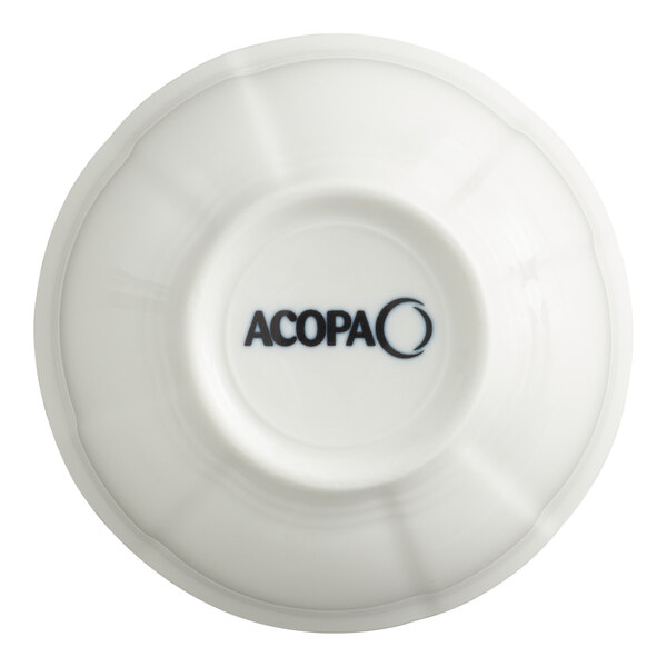 A white scalloped porcelain bouillon cup with the Acopa logo on the bottom.