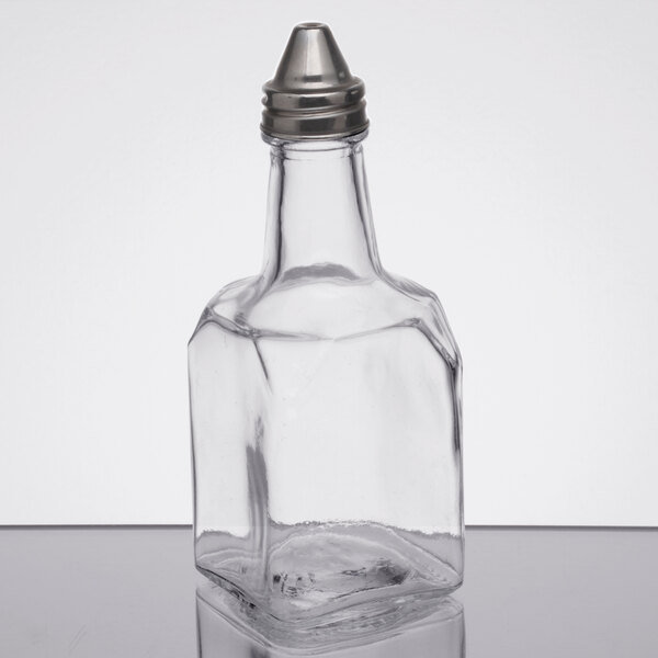 An Anchor Hocking clear glass oil and vinegar bottle with a metal top.