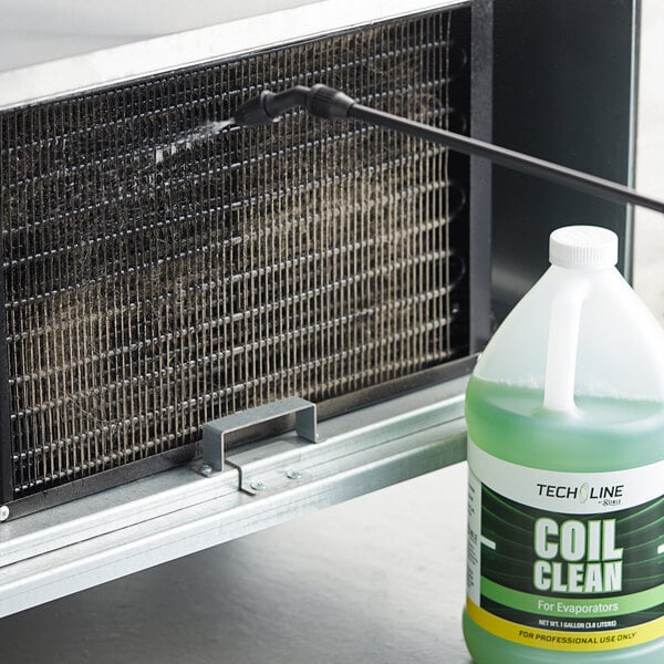 A bottle of Noble Chemical Tech Line Evaporator Concentrated Coil Cleaner next to a window air conditioner.
