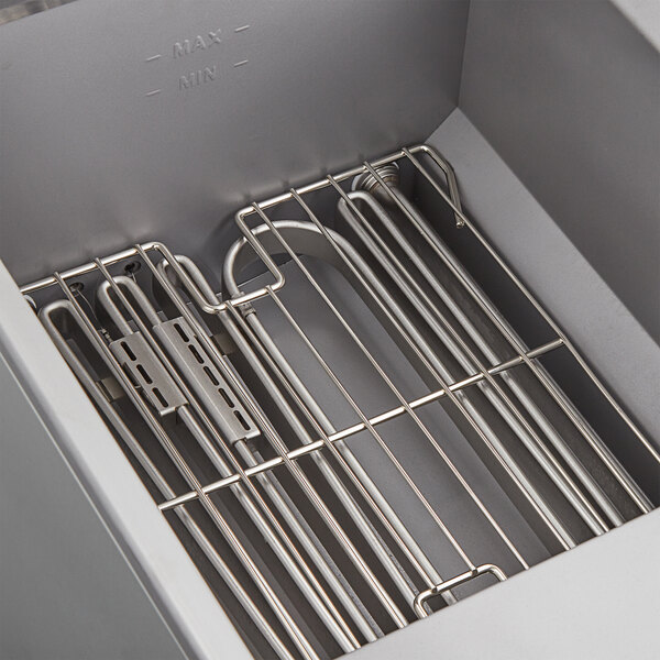 A metal rack inside an Avantco electric floor fryer box.