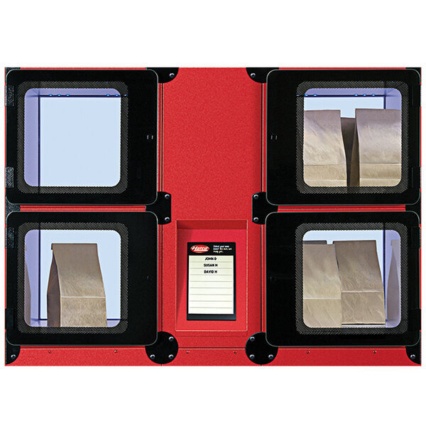 A red Hatco Flav-R 2-Go heated locker system with four bags inside.