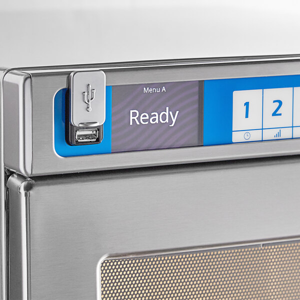 A Solwave commercial microwave with a "Ready" button on a counter.