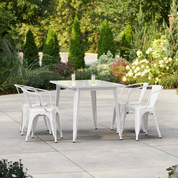 Lancaster Table & Seating Alloy Series 47 1/2" x 29 1/2" Pearl White Standard Height Outdoor Table with 4 Arm Chairs