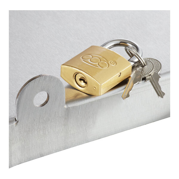 A brass padlock with two keys is attached to a metal surface with a latch.