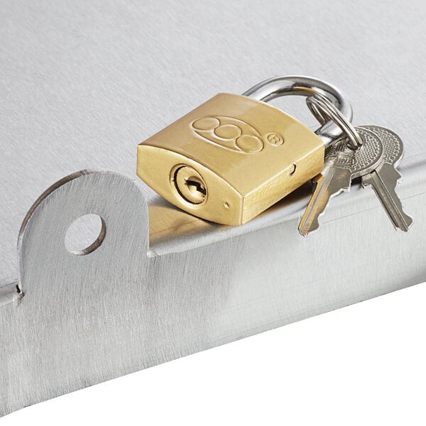 A Regency padlocked sliding lid with 2 keys on a metal surface.