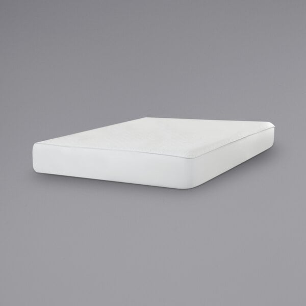 A white Protect-A-Bed mattress pad on a grey surface.