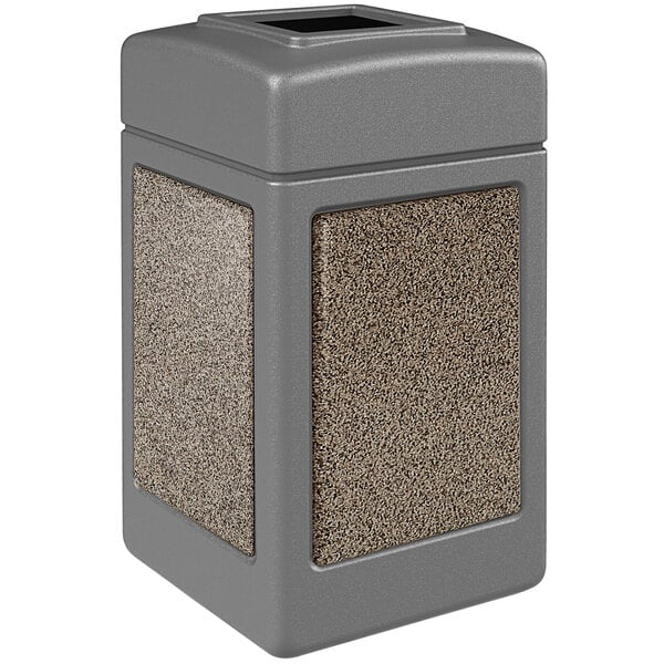 A grey rectangular Commercial Zone StoneTec waste receptacle with square top and riverstone panels.
