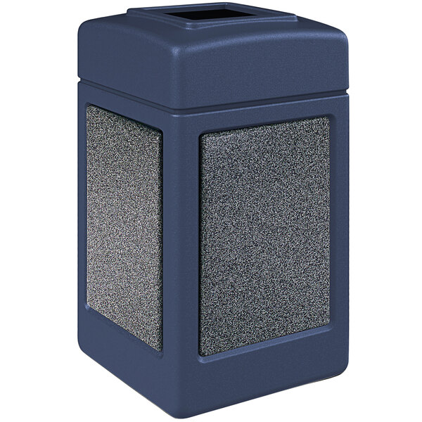 A dark blue stone-look rectangular outdoor trash can with a square open top.