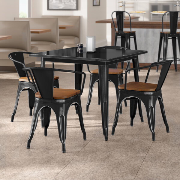 Lancaster Table & Seating Alloy Series 36" x 36" Distressed Onyx Black Standard Height Indoor Table and 4 Arm Chairs with Walnut Wood Seats