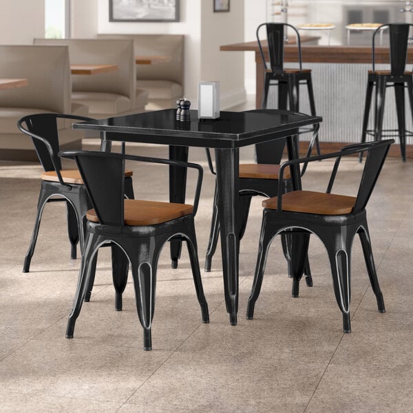Lancaster Table & Seating Alloy Series 32" x 32" Distressed Black Standard Height Indoor Table and 4 Arm Chairs with Walnut Wood Seats