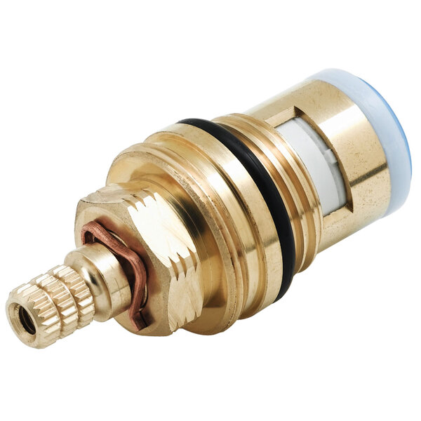 A brass and white ceramic cartridge assembly for a faucet.