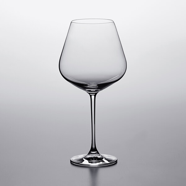 A Lucaris burgundy wine glass on a table.