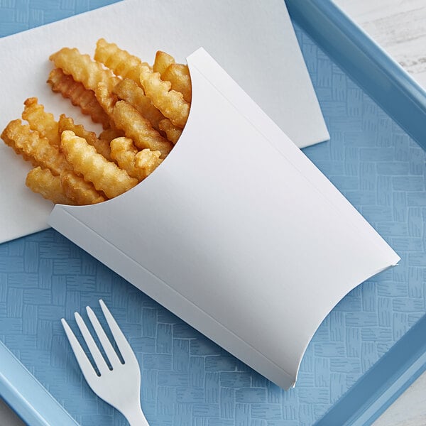 French fries in a white paper tray with a fork.