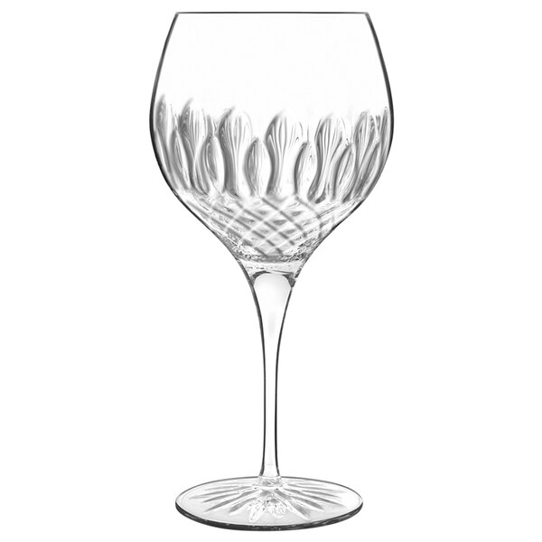 A clear Luigi Bormioli Diamante gin and tonic glass with a design on it.
