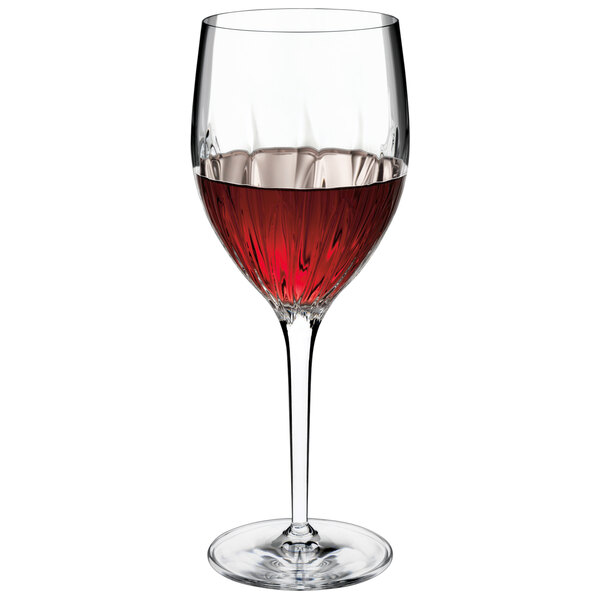 A Luigi Bormioli wine glass filled with red wine.