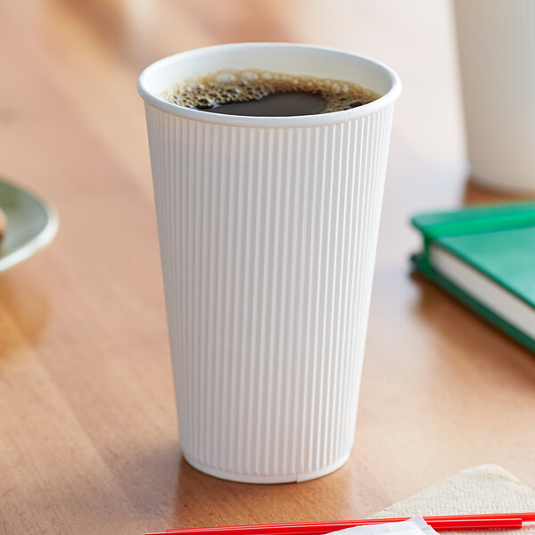 A Choice white paper hot cup filled with coffee on a table.