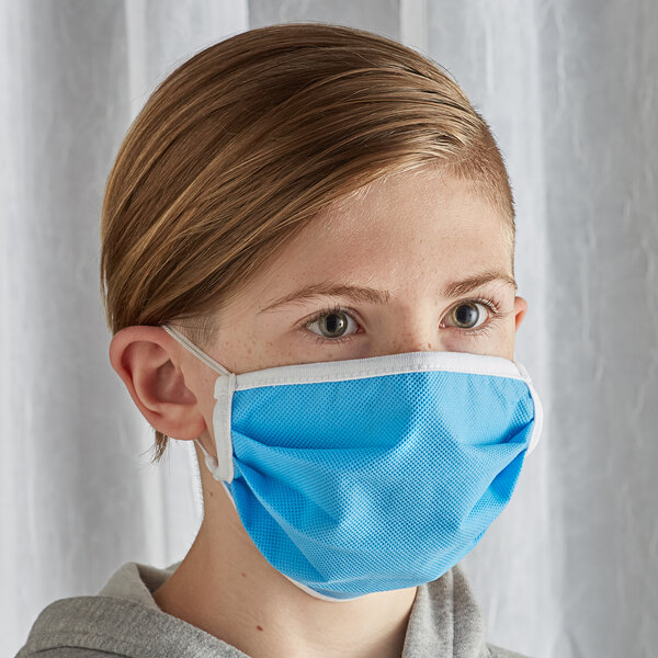 A young person wearing a light blue Mercer Culinary face mask.